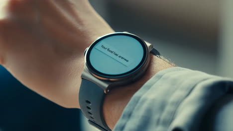close-up of a smartwatch on a wrist displaying a notification