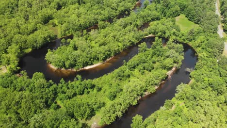 slow aerial reveal shot above schroon river and green valley in upstate new york, usa