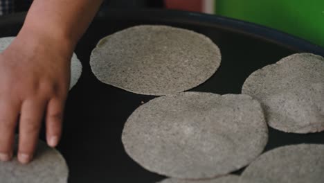 hand cooking tortilla in san cristobal de las casas, chiapas, mexico