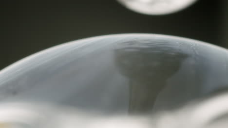 Dropping-transparent-liquid-onto-a-transparent-sphere