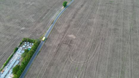 Aerial-tracking-shot-of-an-ambulance-driving-through-the-countryside