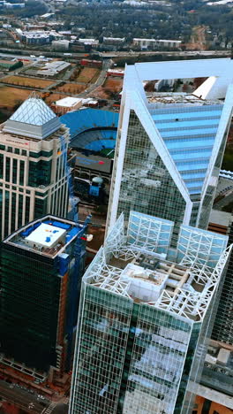 wide multi-lane highway with bridges above dividing the city. drone footage high above the skyscrapers of charlotte, north carolina, usa. vertical video