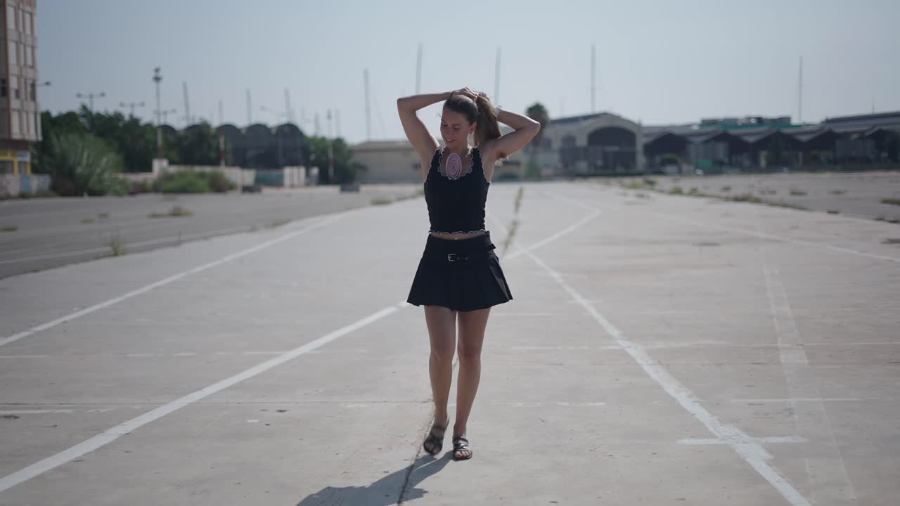 Young Woman Walking in an Empty Parking Lot