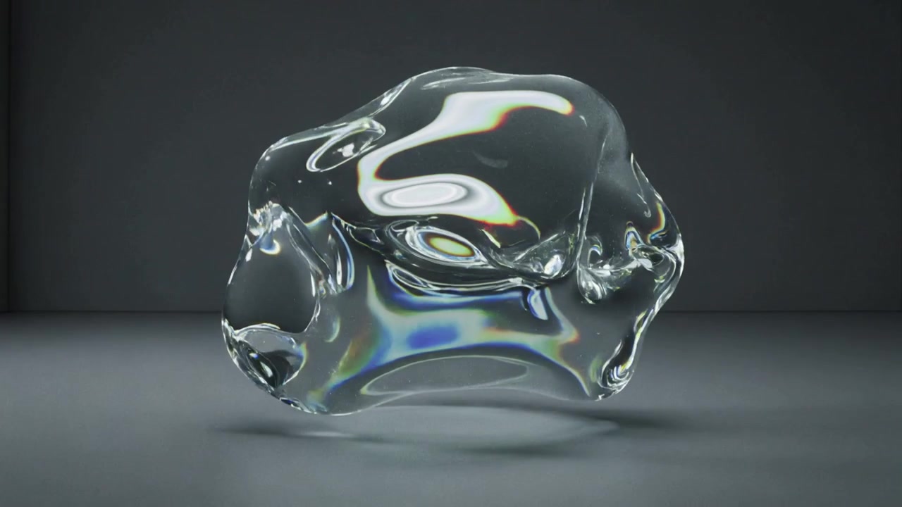 Starting rotating glassy object revealing facets and rainbow over soft shadow in studio