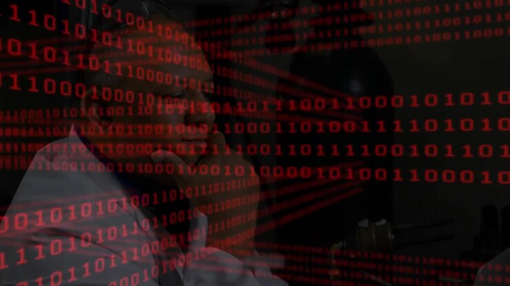 Upon binary code overlay appearing, IT tech reaching for keys and typing in data center diagnostics