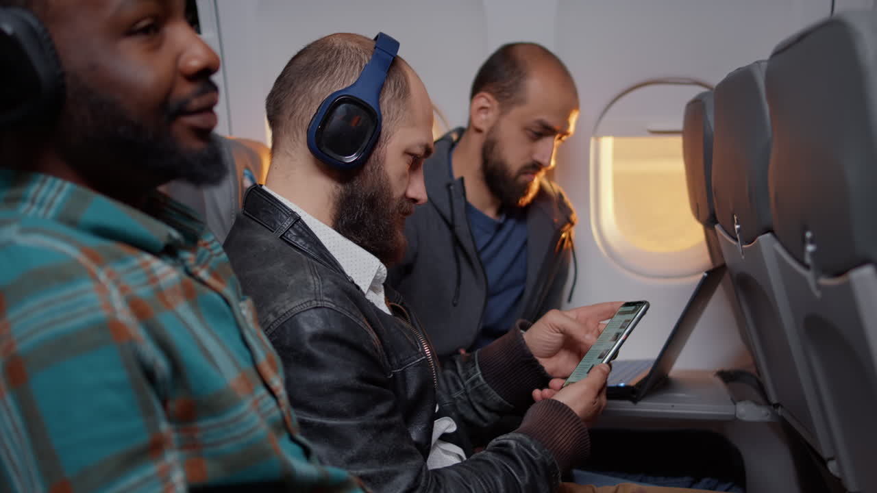 Freelancer using mobile phone during travel flight on plane