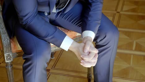 well-dressed man sitting in a chair