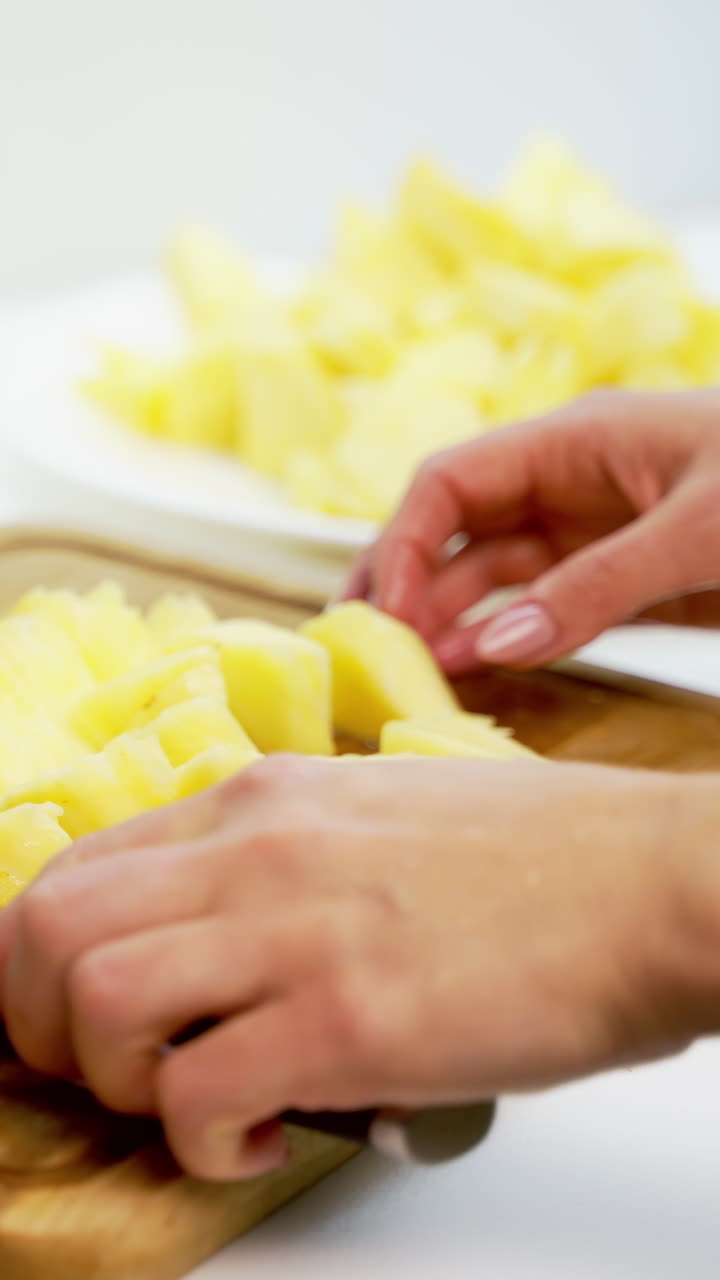 Board with delicious cut pineapple on table. Composition with fresh ripe pineapples on white background