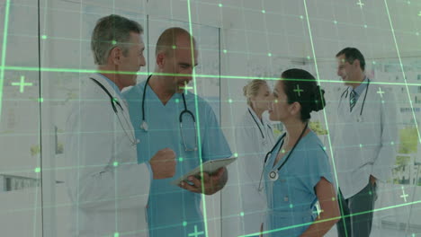 healthcare team reviewing tablet in hospital corridor, with green digital grid overlay