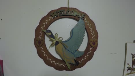 wooden wall art of a goose in a kitchen that reads welcome