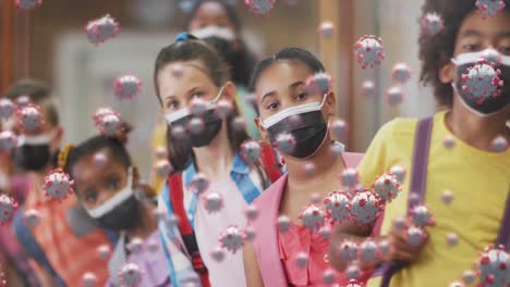 animation of covid-19 cells on group of diverse kids wearing face masks standing in queue at school