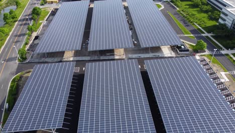 Solar-panels-installed-in-a-corporate-office-complex-parking-lot-and-solar-panels-on-the-office-complex-buildings