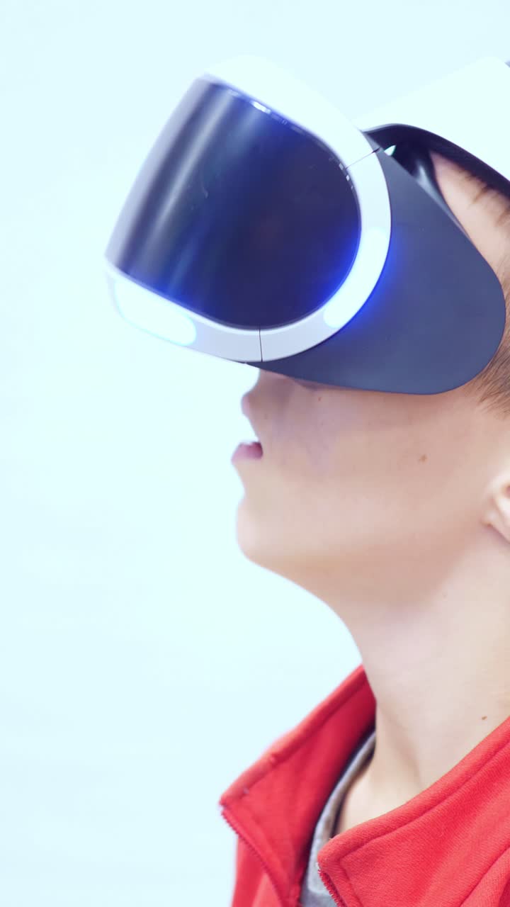 Young boy wearing virtual reality headset, immersed in digital experience, showcasing modern technology and interactive gaming environment