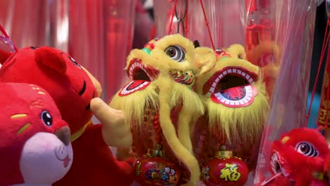 chinese new year decorative ornaments, such as yellow lions, seen for sale at a shop during the lunar chinese new year in hong kong