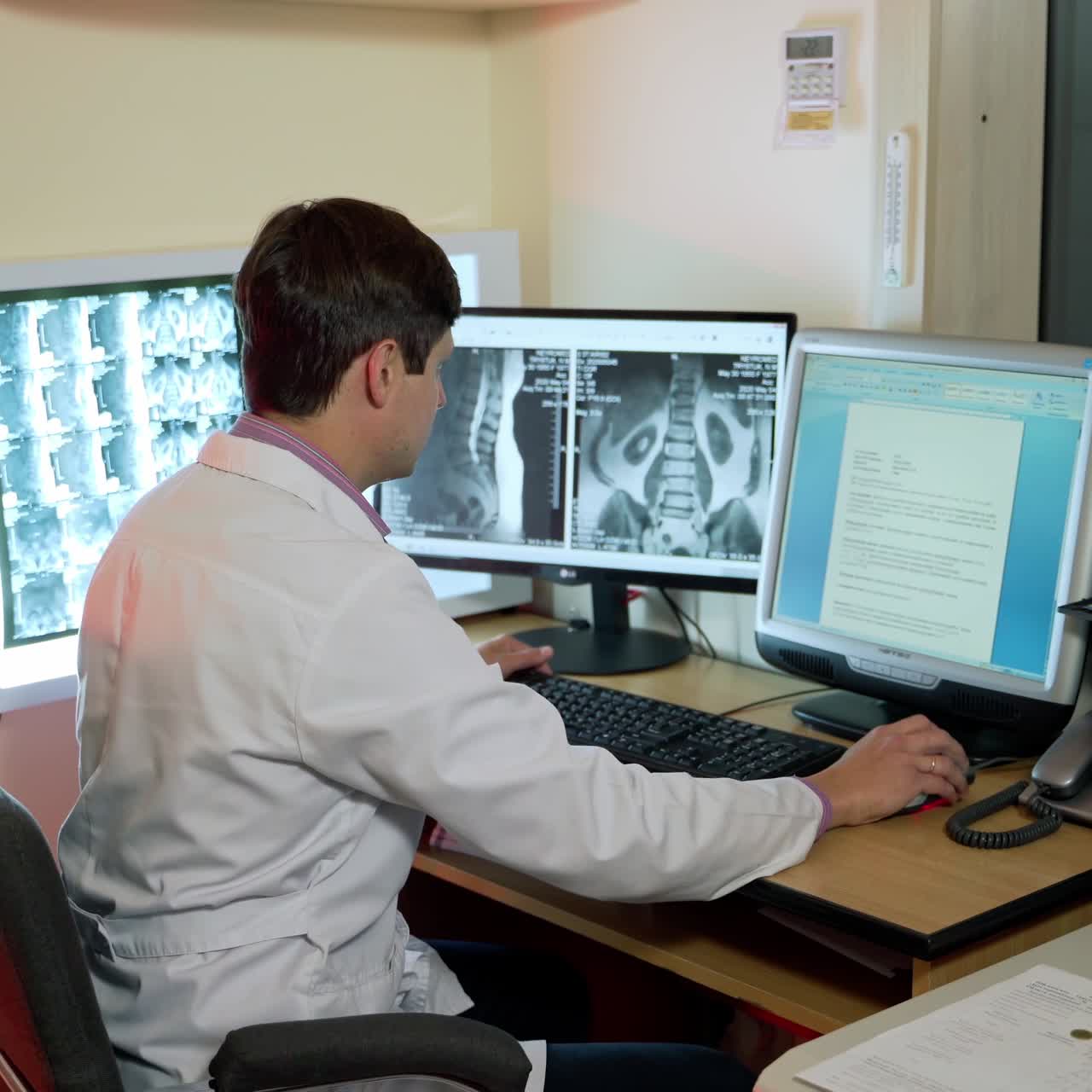 Male Scientist Working On Computer. Medical scientist working with scan images