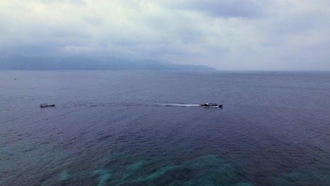 aerial static camera view of calm sea under cloudy sky in the gili islands, ideal for serene travel content