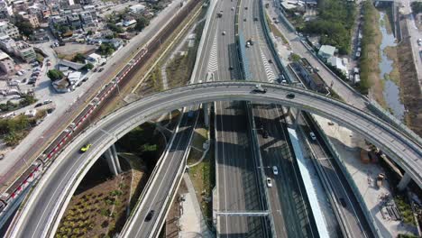 traffic on a massive highway interchange with multiple levels and loop shaped road in hong kong, aerial view