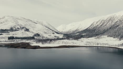 towering snow mountains near svolvaer village in vagan municipality, nordland county, norway. aerial shot