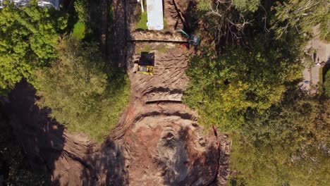 construction site with excavation work near residential homes and trees