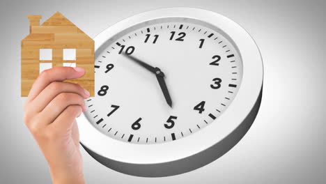 holding wooden house cutout, hand over clock animation
