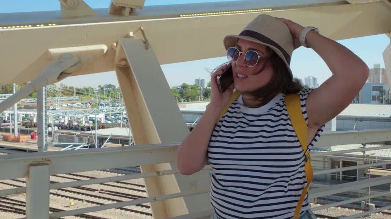 Tourist Having a Call on Bridge at Terminal