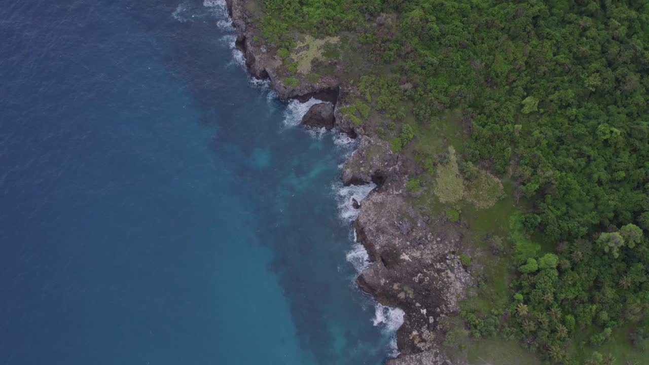 Top down of the rocky coast at Sumba island during sunrise, aerial