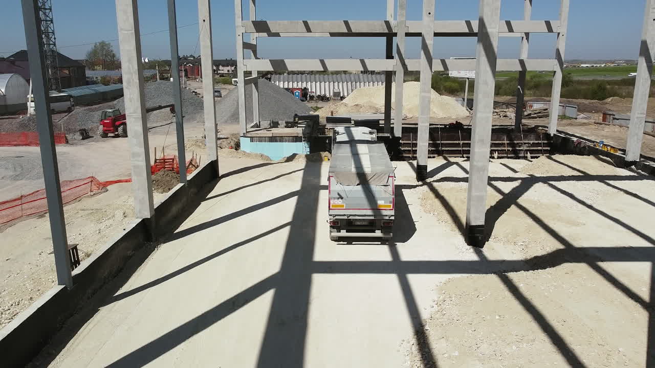 Construction site of a large building with a truck