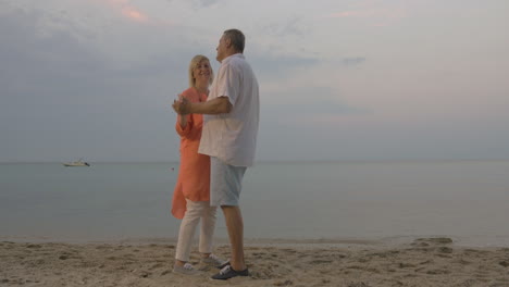 Pareja-Mayor-Bailando-En-La-Playa