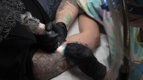 Tattoo artist creating an intricate design on a client's arm in a timelapse video, showcasing precision and professional tools.