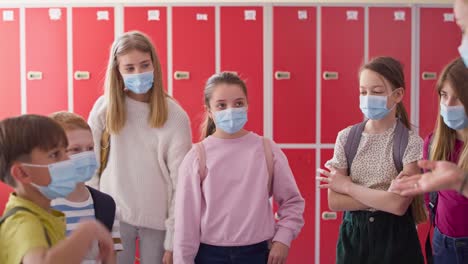 video of teacher and children talking in the school corridor