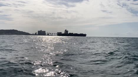 cargo ship on its way to the atlantic ocean, leaving the tagus river