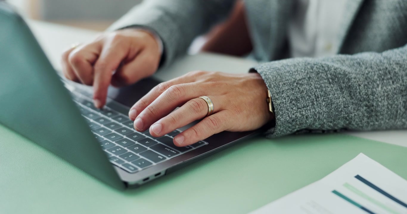 Businessman Typing on Laptop in Professional Office Setting