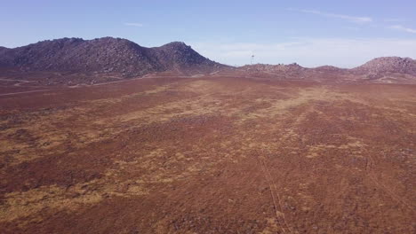 White-Drone-Flies-Over-Desert-Scene-Carrying-Prey-for-Training-Falcons