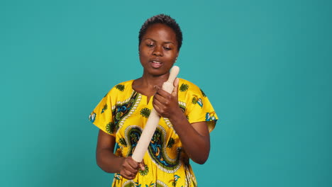 Strong-confident-woman-threatening-to-fight-with-a-rolling-pin