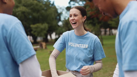 group of volunteers high five each other while packing boxes for donation