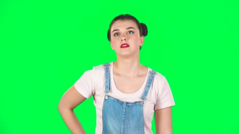woman holding a credit card in front of a green screen