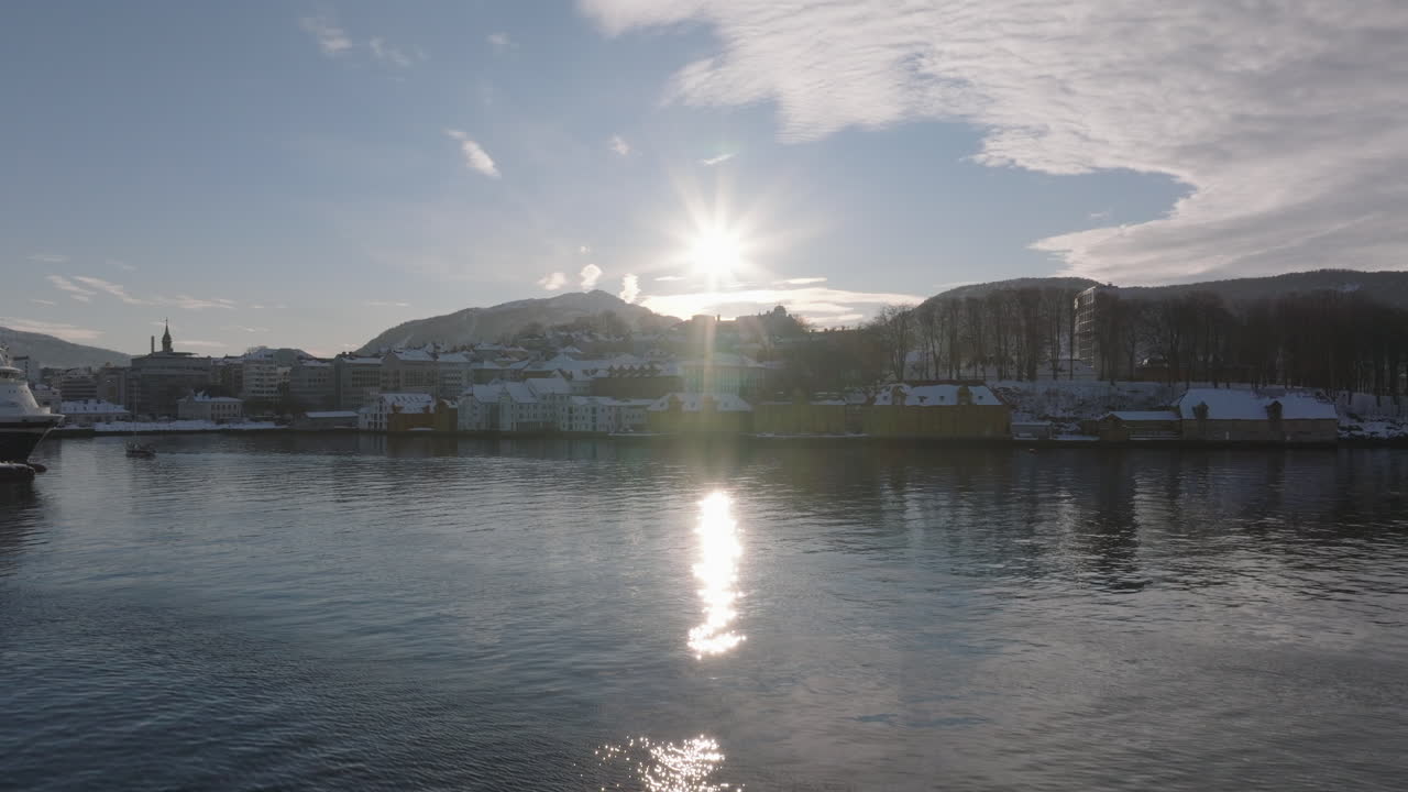 Rising drone crane shot of the waterfront in Bergen, Norway on a sunny winter day