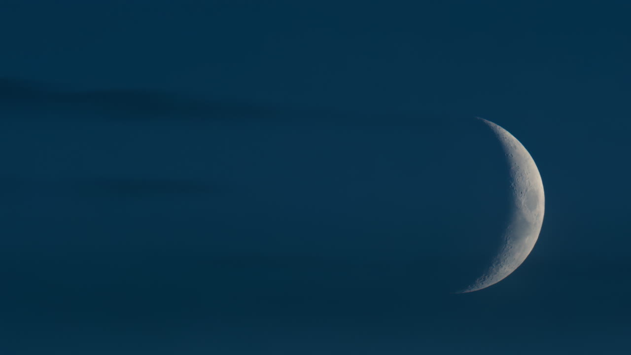 Close up of crescent moon illuminated against a deep blue sky