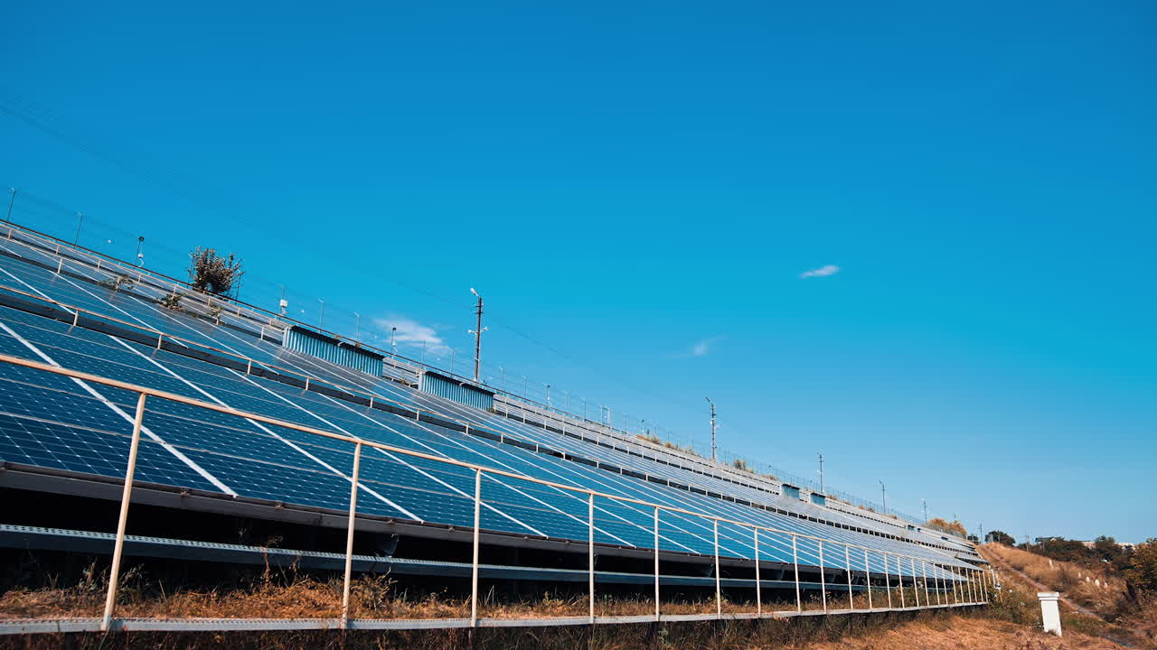 New solar farm near the road. Photovoltaic panels receive ecological energy from the sun. Sustainable source of clean energy.
