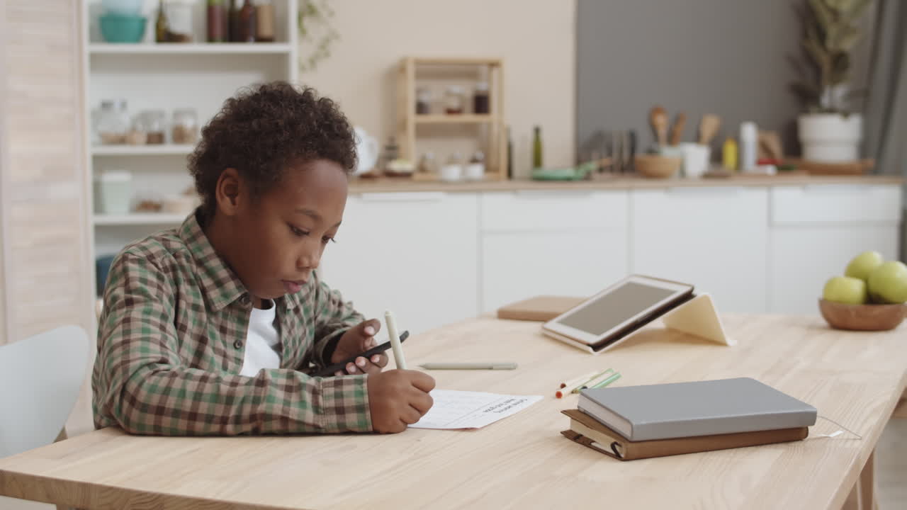 Child Doing Homework in Kitchen