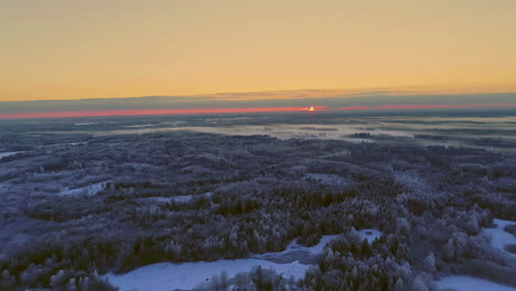 red sunset or sunrise over harsh winter landscape, aerial drone view