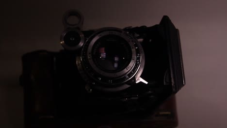 Close-Up-of-The-Folding-Vintage-Photo-Film-Camera-in-the-Dark