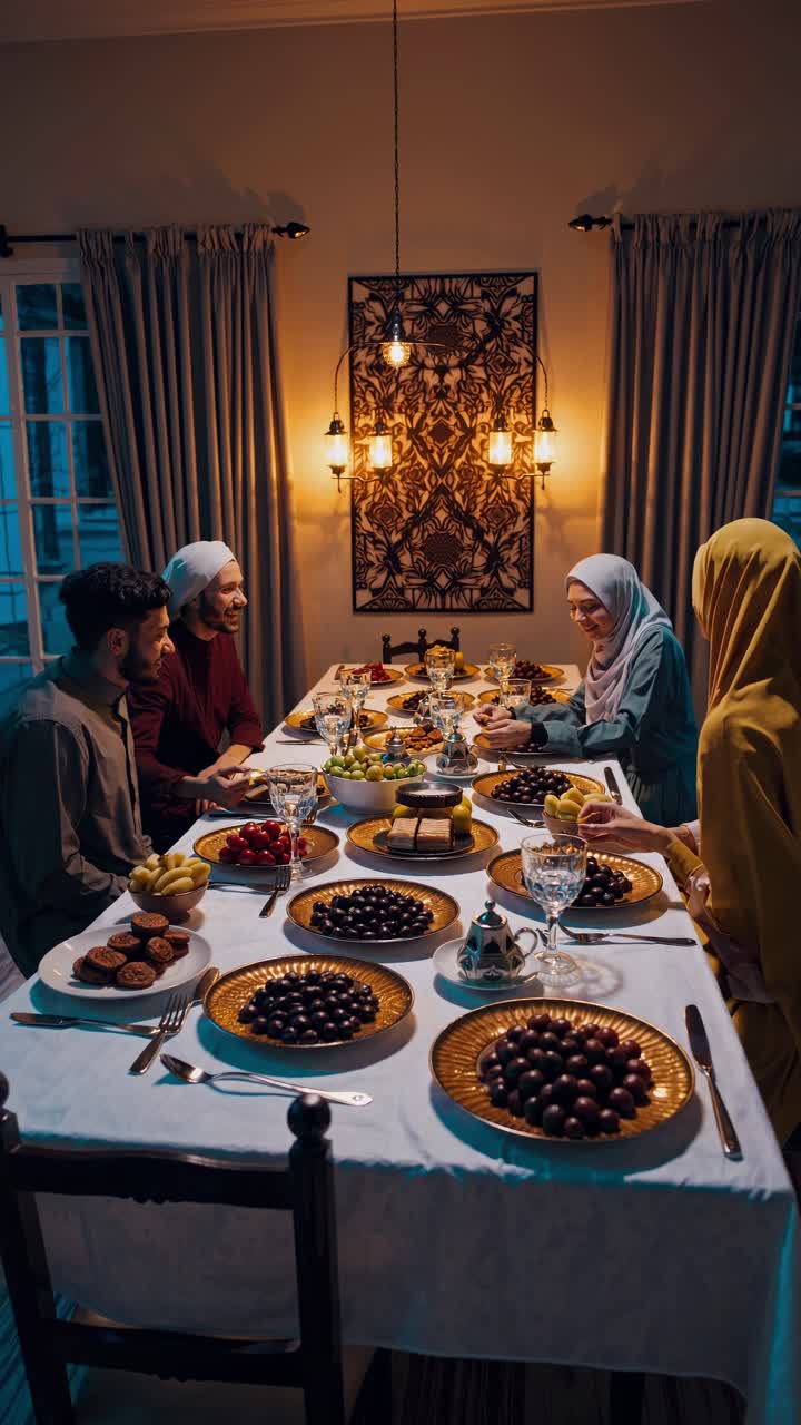 Muslim family sitting at a table, enjoying a delicious iftar dinner during the holy month of Ramadan, sharing food and togetherness in a warm and inviting atmosphere