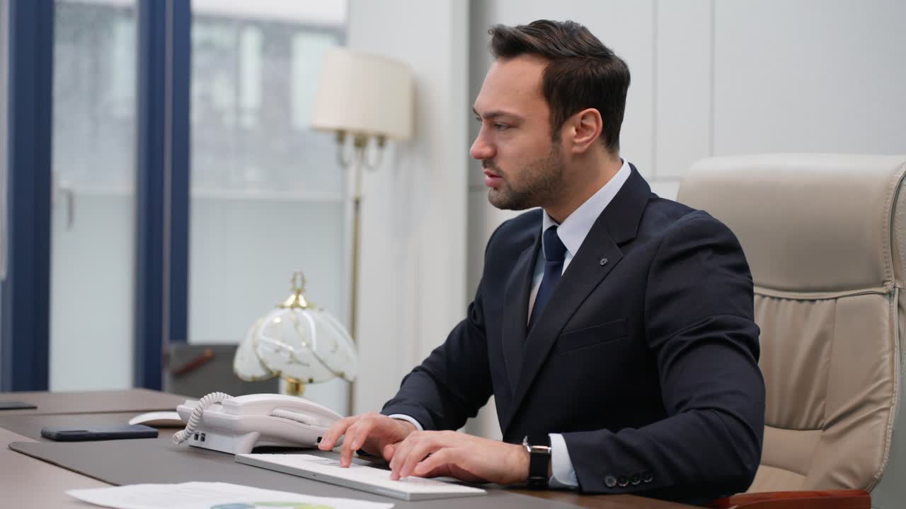 Angry business man having phone call in fancy office, deadline. Nervous manager typing on computer yelling at employee while reviewing paper documents in slow motion