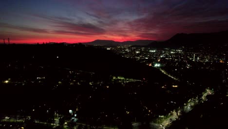 stunning sunset over night city with mountains