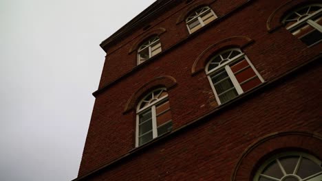 large-gloomy-brick-house-with-white-windows