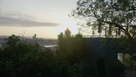 hi res cafe ledge view, barcelona spain city skyline with golden sunrise in 6k as birds fly