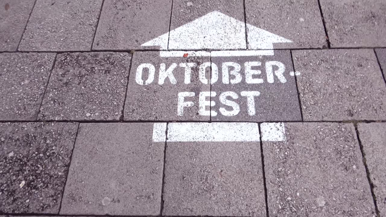 We follow some costumed lederhosen wearing people who are heading for Oktoberfest