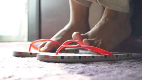 Woman wearing flip-flops on a carpet