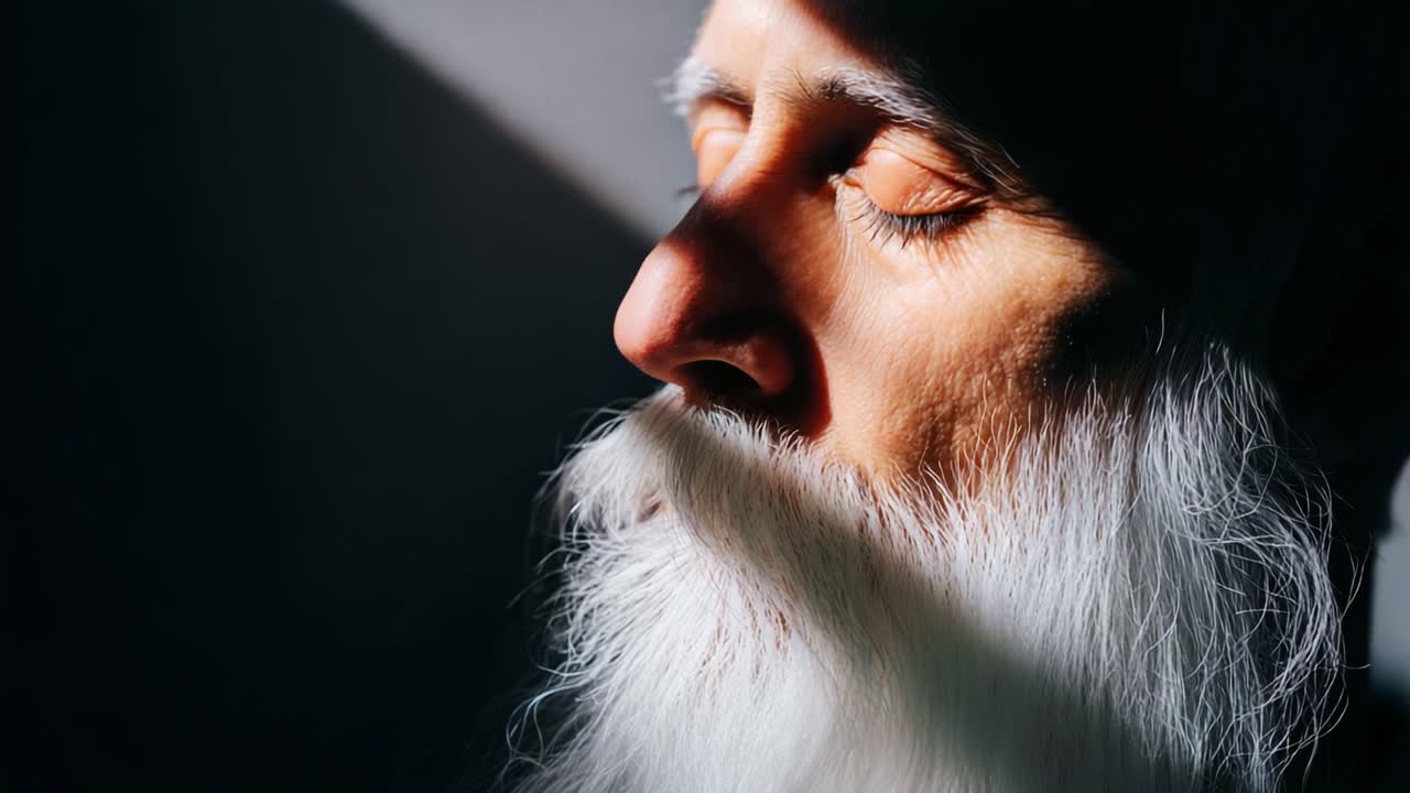 A Tranquil Moment of Reflection and Serenity: Captivating Scenes of Contemplation Featuring a Man with a White Beard Illuminated by Soft Light and Shadows